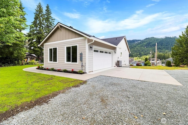 281 Shallow Shore Rd, Bellingham, WA 98229 - view of side of property with driveway, board and batten siding, a yard, a garage, and a mountain view
