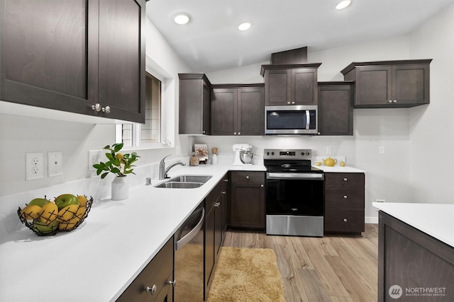 281 Shallow Shore Rd, Bellingham, WA 98229 - kitchen with stainless steel appliances, light wood-style flooring, dark brown cabinetry, light countertops, and recessed lighting