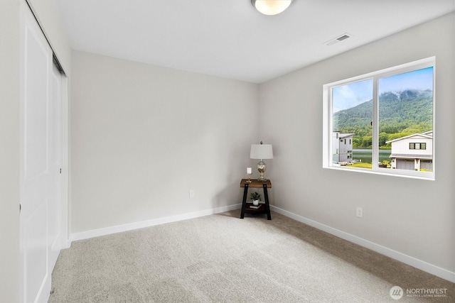 281 Shallow Shore Rd, Bellingham, WA 98229 - unfurnished bedroom featuring carpet, a closet, and a mountain view