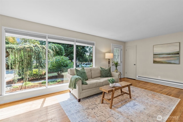 13523 23rd Pl NE, Seattle, WA 98125 - living room with wood finished floors and a baseboard heating unit