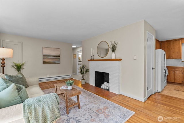 13523 23rd Pl NE, Seattle, WA 98125 - living room featuring a baseboard heating unit, light wood-type flooring, and a brick fireplace