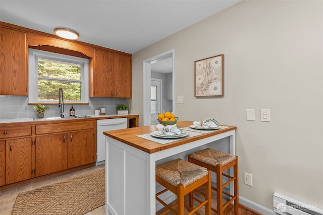 13523 23rd Pl NE, Seattle, WA 98125 - kitchen with white dishwasher, baseboard heating, a kitchen breakfast bar, tasteful backsplash, and brown cabinets