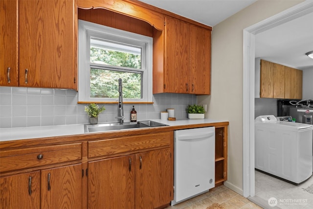 13523 23rd Pl NE, Seattle, WA 98125 - kitchen featuring washer / dryer, dishwasher, tasteful backsplash, and brown cabinetry