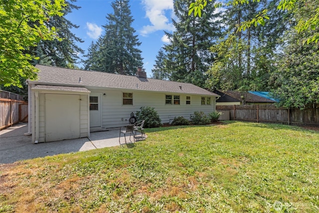 13523 23rd Pl NE, Seattle, WA 98125 - back of house with a fenced backyard, a chimney, and a patio area