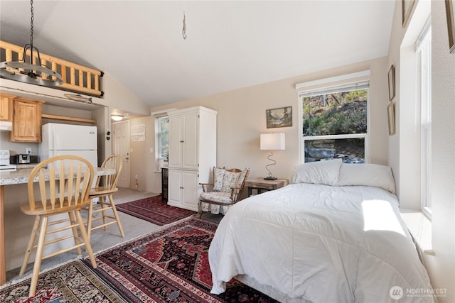 968 Cagle Gulch Rd, Chelan, WA 98816 - bedroom with freestanding refrigerator, lofted ceiling, and light carpet