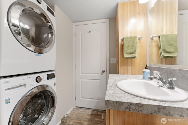 968 Cagle Gulch Rd, Chelan, WA 98816 - laundry room with stacked washer / dryer and wood finished floors
