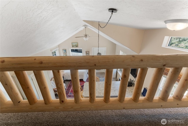 968 Cagle Gulch Rd, Chelan, WA 98816 - stairway with lofted ceiling, a ceiling fan, and a textured ceiling