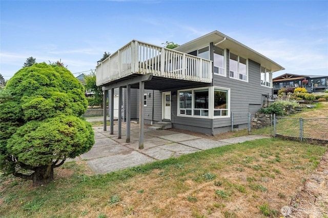 4815 N Huson St, Tacoma, WA 98407 - back of property featuring a wooden deck, a gate, and a patio