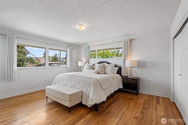 4815 N Huson St, Tacoma, WA 98407 - bedroom with hardwood / wood-style flooring, a textured ceiling, and a closet