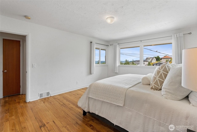 4815 N Huson St, Tacoma, WA 98407 - bedroom featuring hardwood / wood-style floors and a textured ceiling