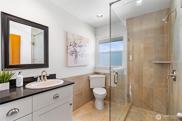 4815 N Huson St, Tacoma, WA 98407 - bathroom featuring tile walls, a shower stall, vanity, a wainscoted wall, and tile patterned flooring