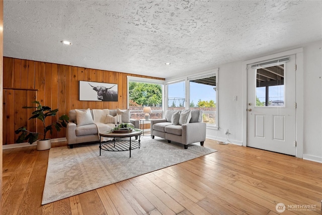 4815 N Huson St, Tacoma, WA 98407 - living area with light wood-style floors, a textured ceiling, and wooden walls