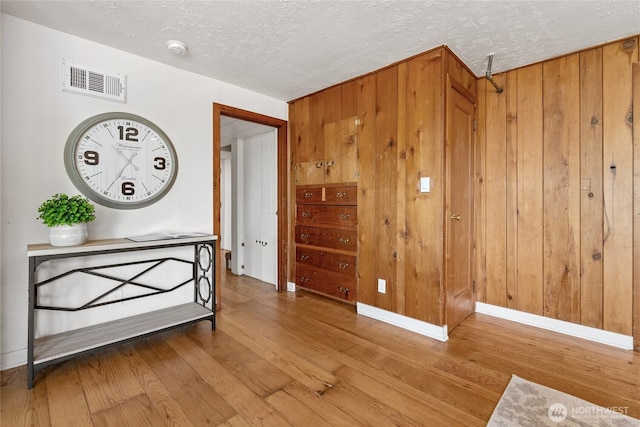 4815 N Huson St, Tacoma, WA 98407 - spare room with wood finished floors, a smoke detector, a textured ceiling, and wood walls