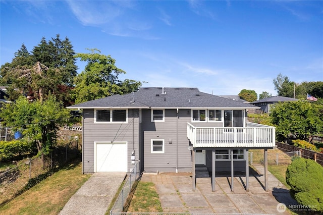 4815 N Huson St, Tacoma, WA 98407 - back of property with a patio area, a deck, an attached garage, roof with shingles, and driveway