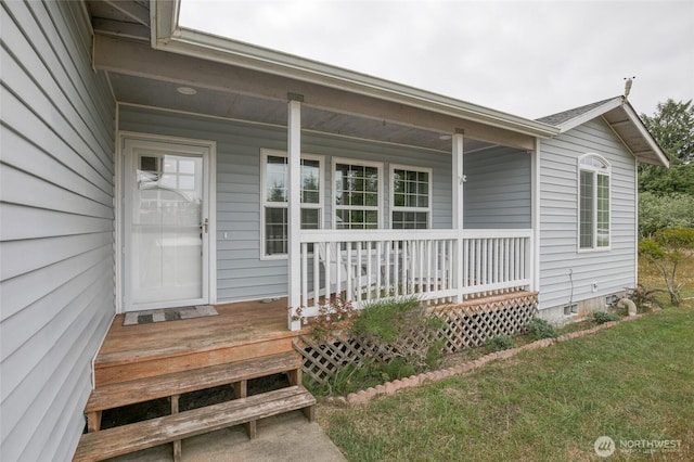 117 Bufflehead St SW, Ocean Shores, WA 98569 - property entrance featuring a porch and a yard