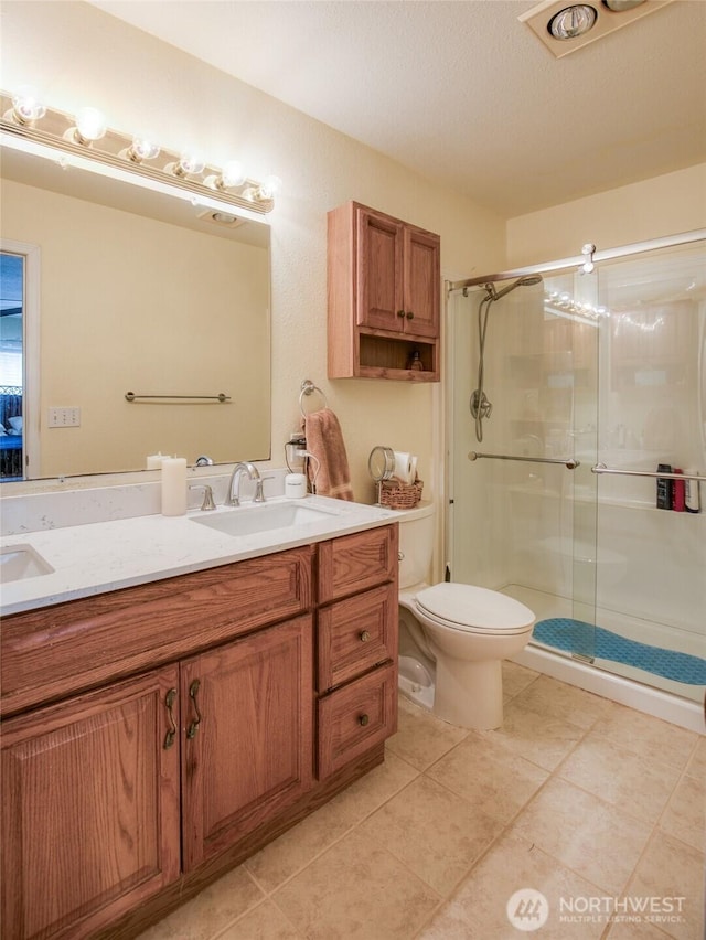 117 Bufflehead St SW, Ocean Shores, WA 98569 - full bath featuring double vanity, a stall shower, and tile patterned floors