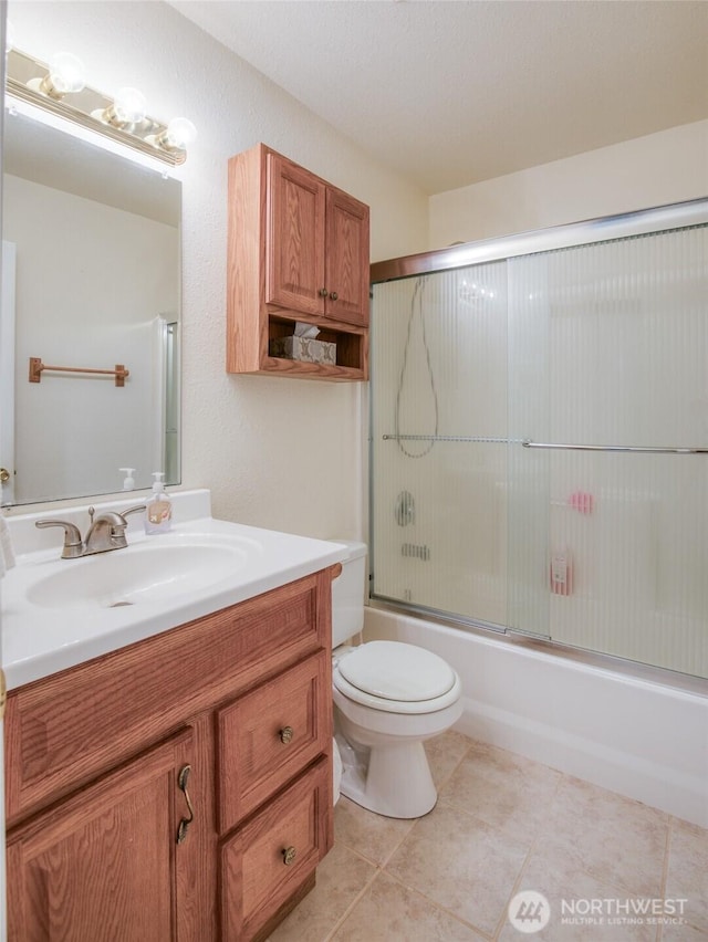 117 Bufflehead St SW, Ocean Shores, WA 98569 - bathroom featuring vanity, bath / shower combo with glass door, and tile patterned flooring