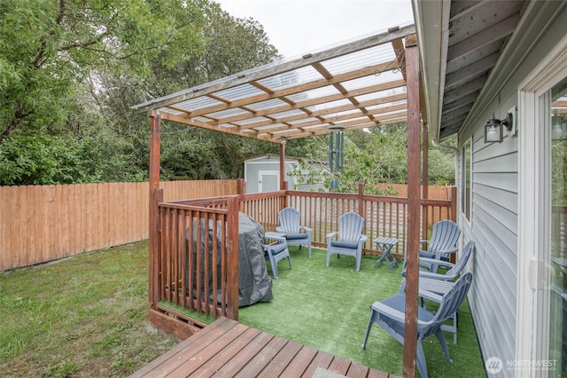 117 Bufflehead St SW, Ocean Shores, WA 98569 - wooden terrace with a storage unit and a fenced backyard