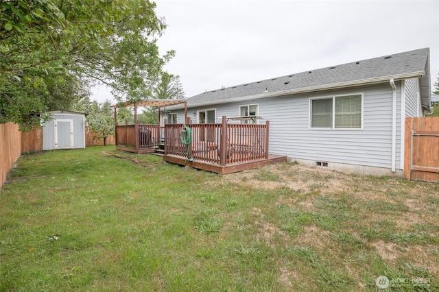 117 Bufflehead St SW, Ocean Shores, WA 98569 - rear view of house with a deck, a storage shed, a fenced backyard, and a shingled roof