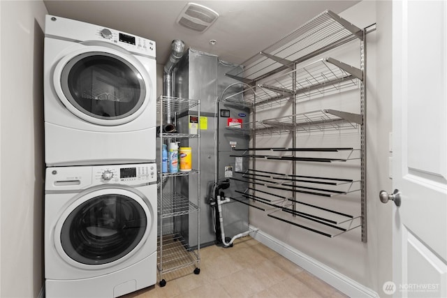 18707 SE Newport Way Unit 208, Issaquah, WA 98027 - washroom featuring stacked washing machine and dryer and baseboards
