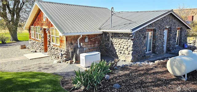 20354 Adrian Rd NE, Soap Lake, WA 98851 - view of side of home featuring stone siding and a metal roof