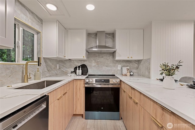 15409 Westshore Dr SE, Yelm, WA 98597 - kitchen featuring appliances with stainless steel finishes, wall chimney exhaust hood, light stone countertops, tasteful backsplash, and white cabinets