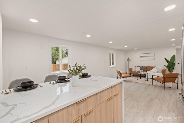 15409 Westshore Dr SE, Yelm, WA 98597 - kitchen featuring light brown cabinets, modern cabinets, recessed lighting, light wood-style floors, and light stone counters