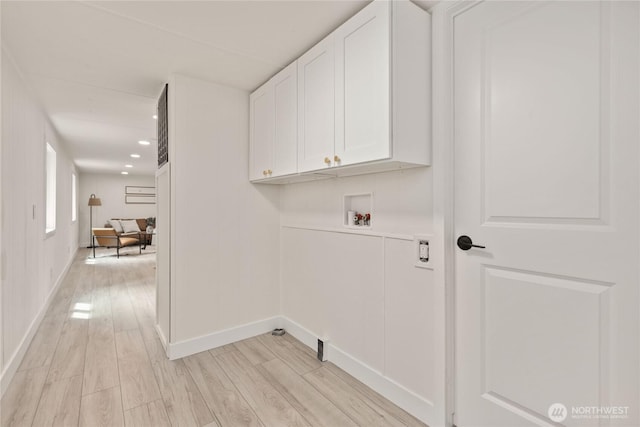15409 Westshore Dr SE, Yelm, WA 98597 - laundry room featuring hookup for a washing machine, cabinet space, light wood finished floors, and recessed lighting