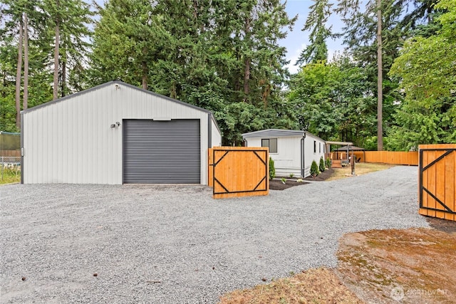 15409 Westshore Dr SE, Yelm, WA 98597 - detached garage with gravel driveway and view of wooded area