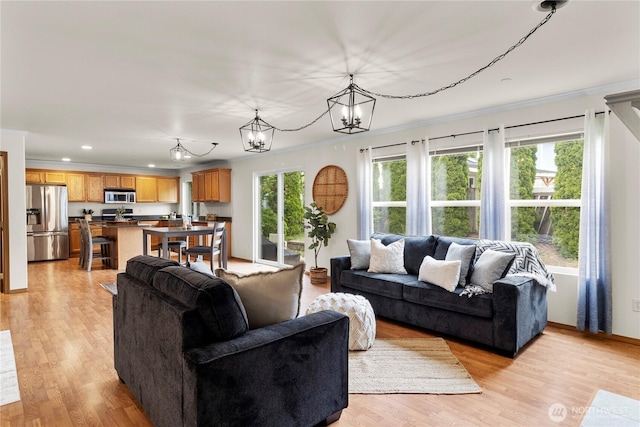1662 Jensen Ave, Dupont, WA 98327 - living room featuring crown molding, a chandelier, recessed lighting, and light wood finished floors