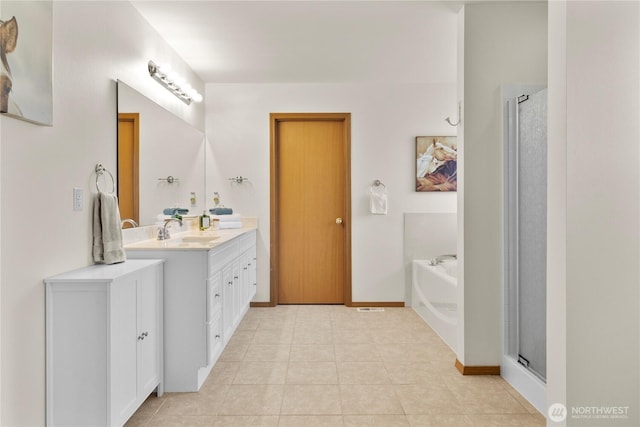 1662 Jensen Ave, Dupont, WA 98327 - full bath with vanity, a stall shower, a garden tub, and tile patterned floors