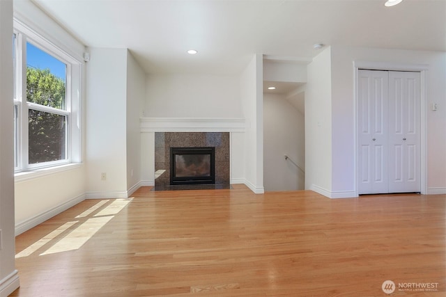 1426A NW 59th St, Seattle, WA 98107 - unfurnished living room with light wood finished floors, recessed lighting, and a tiled fireplace