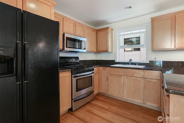 1426A NW 59th St, Seattle, WA 98107 - kitchen with stainless steel appliances, light brown cabinetry, light wood-style floors, and dark stone counters