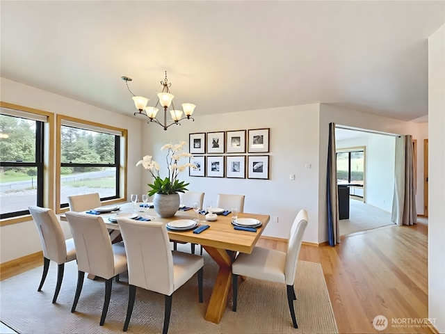 412 Doe Run Rd, Sequim, WA 98382 - dining space with light wood-style flooring, a chandelier, and healthy amount of natural light