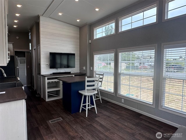 20 Golden Sands Pl, Sequim, WA 98382 - kitchen with dark countertops, white cabinets, dark wood-style floors, a kitchen bar, and recessed lighting