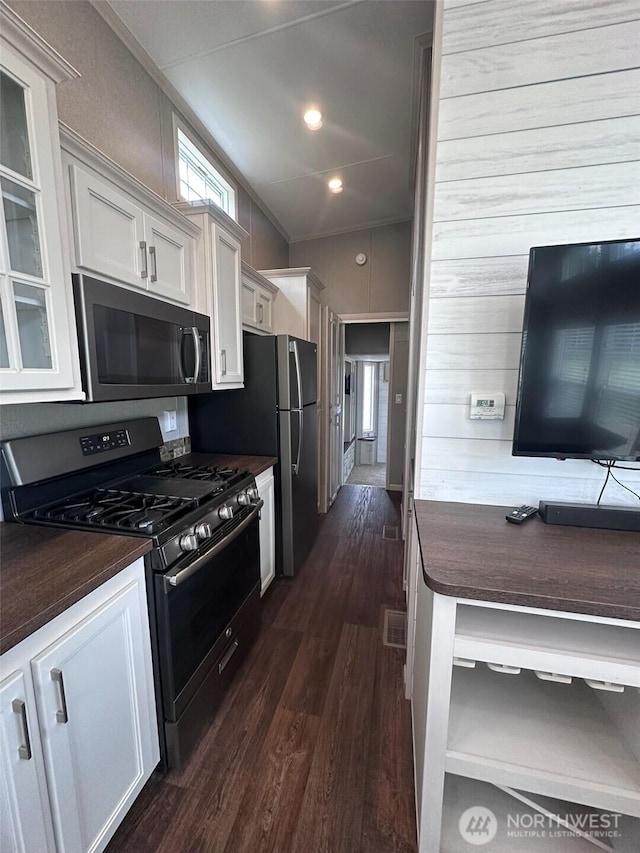 20 Golden Sands Pl, Sequim, WA 98382 - kitchen with black microwave, gas range, dark countertops, dark wood finished floors, and ornamental molding