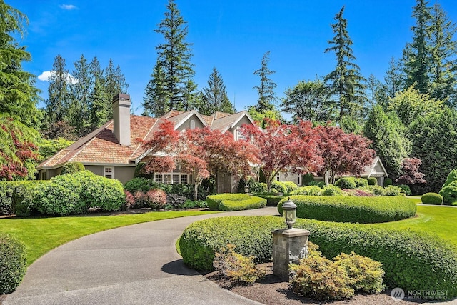24817 NE 20th St, Sammamish, WA 98074 - view of front of home featuring a chimney, a front lawn, and stucco siding