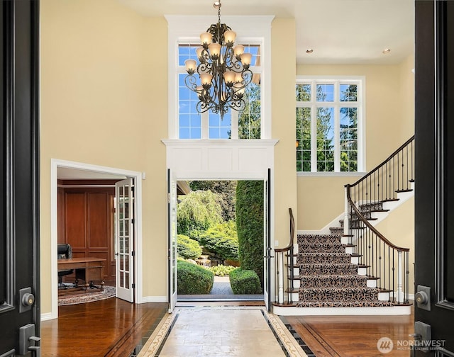 24817 NE 20th St, Sammamish, WA 98074 - foyer entrance with a chandelier, stairs, wood finished floors, and a high ceiling
