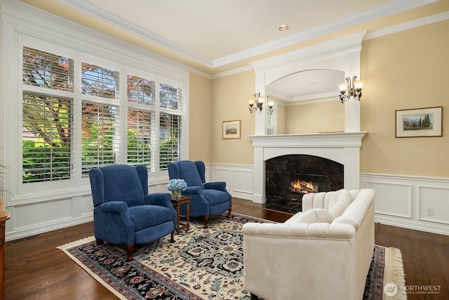 24817 NE 20th St, Sammamish, WA 98074 - living room featuring a high end fireplace, plenty of natural light, crown molding, dark wood-style floors, and a wainscoted wall