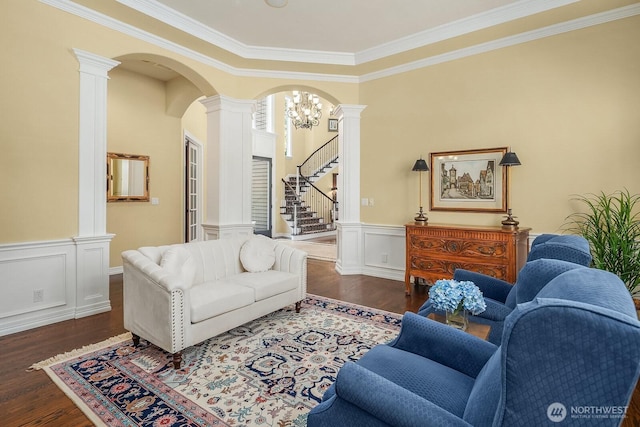 24817 NE 20th St, Sammamish, WA 98074 - living room with decorative columns, ornamental molding, wood finished floors, arched walkways, and wainscoting