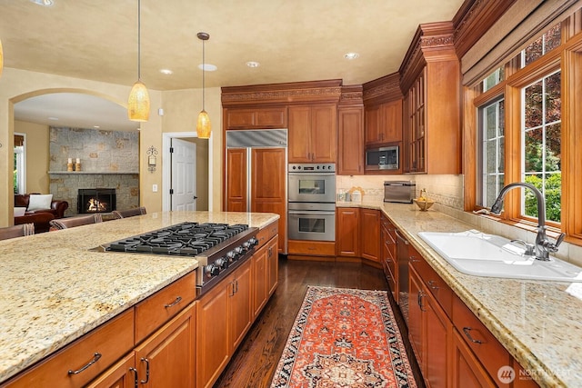 24817 NE 20th St, Sammamish, WA 98074 - kitchen with built in appliances, plenty of natural light, dark wood-type flooring, light stone countertops, and recessed lighting