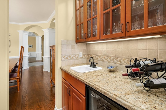 24817 NE 20th St, Sammamish, WA 98074 - bar with decorative columns, ornamental molding, arched walkways, tasteful backsplash, and dark wood finished floors