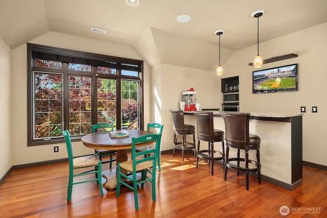 24817 NE 20th St, Sammamish, WA 98074 - indoor dry bar featuring vaulted ceiling, wood finished floors, and hanging light fixtures
