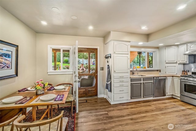 10218 NE 65th St, Kirkland, WA 98033 - kitchen with appliances with stainless steel finishes, light wood-style flooring, light countertops, white cabinetry, and recessed lighting