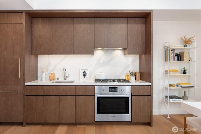 121 Stewart St Unit 1407, Seattle, WA 98101 - kitchen featuring stainless steel oven, gas stovetop, light countertops, and light wood-style floors