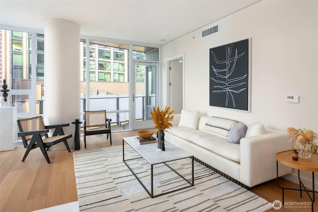 121 Stewart St Unit 1407, Seattle, WA 98101 - living area with wood finished floors and a wall of windows