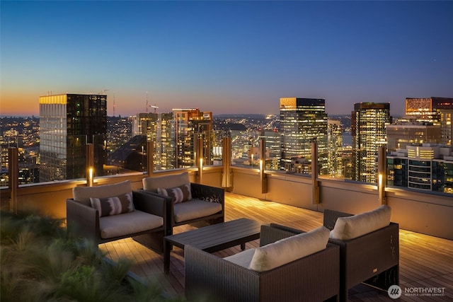 121 Stewart St Unit 1407, Seattle, WA 98101 - patio terrace at dusk with an outdoor living space and a city view