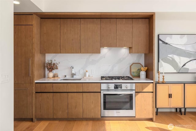 121 Stewart St Unit 1407, Seattle, WA 98101 - kitchen featuring appliances with stainless steel finishes, light countertops, and light wood finished floors