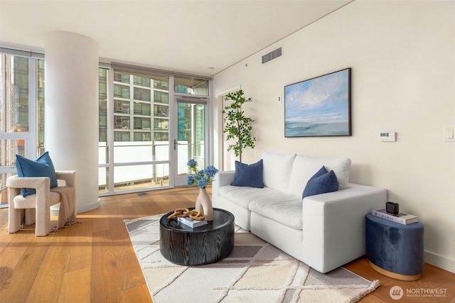 121 Stewart St Unit 1407, Seattle, WA 98101 - living room with wood finished floors and a wall of windows
