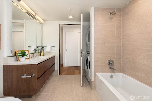 121 Stewart St Unit 1407, Seattle, WA 98101 - bathroom with stacked washing machine and dryer, vanity, and shower / bathtub combination